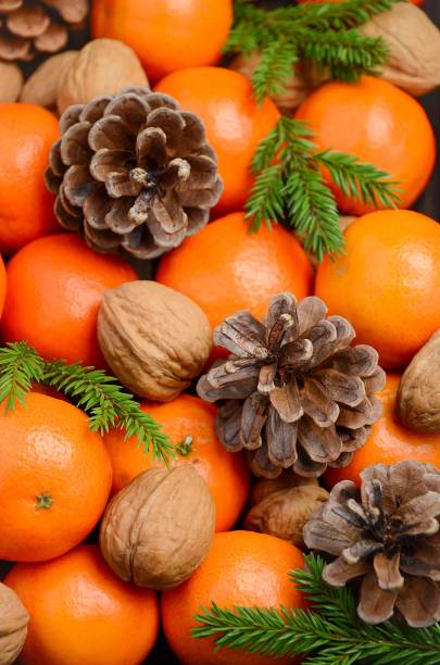 istock Fresh tangerine clementine with nuts and cones 837564952