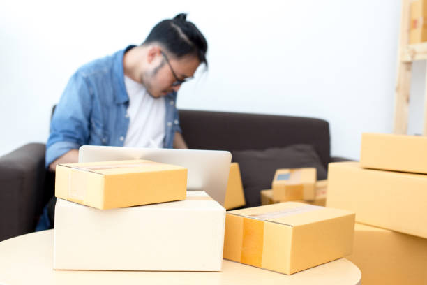 istock Box in the foreground. Blurred with Young Owner Man receive Order form Customer , SME, Delivery, Man with Online Business or SME Concept. 837572274