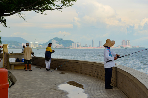 Georgetown, Malaysia - September 15, 2012: Fishermen on the waterfront of Georgetown, Penang Island, Malaysia.