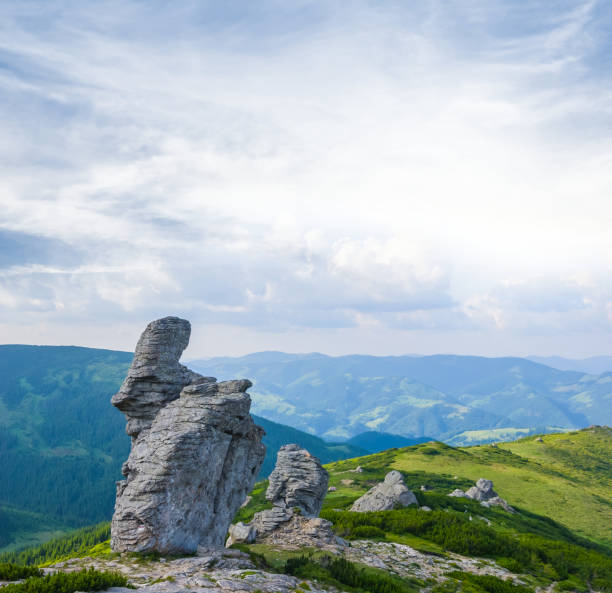 istock alone rock among a green hills at the sunset 837576406