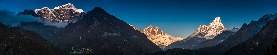 Stars glittering in the clear high altitude skies over the snow capped peaks of Taboche, Everest, Nuptse, Lhotse and Ama Dablam overlooking Tengboche monastery in the Khumub valley and the remote Sherpa village of Phortse deep in the Himalaya mountains of Nepal.