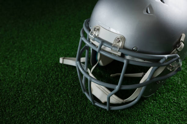 istock American football head gear over artificial turf 837578312