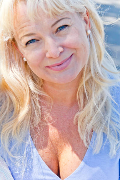 istock Blond woman with blue eyes in sunny day 837578498