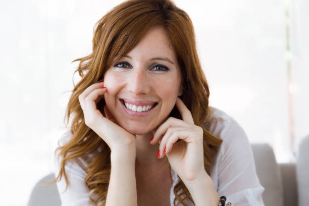 istock Beautiful young woman looking at camera at home. 837582634