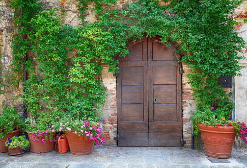 Beautiful old wooden door decorated with flowers, Italy