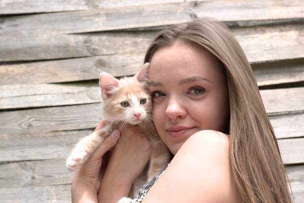 istock Beautiful smiling girl holding a young cat. 837588424
