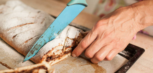 istock Woman cutting chocolate cake with sugar decoration with kitchen knife 837600436