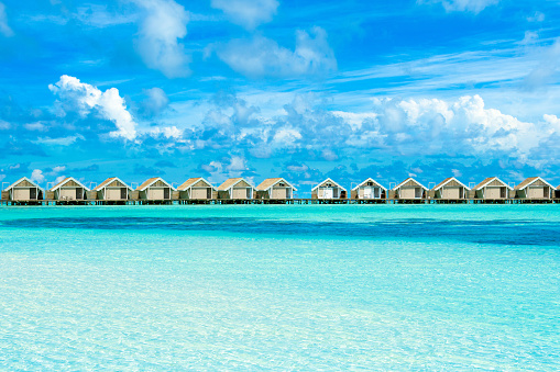 South Atoll, Dhidhoofinolhu, Maldives - July 20, 2017:Tropical landscape with  wooden villas over water of the Indian Ocean, Maldives