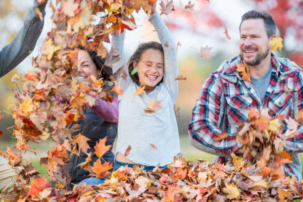 istock Family Playing In Leaves 837620264