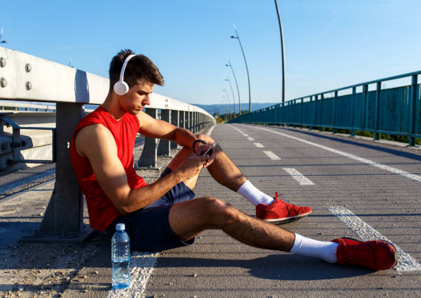 istock Portrait of young athlete man using mobile phone. 837640746