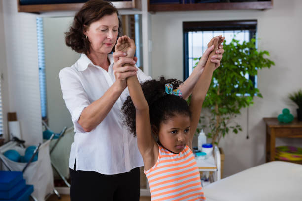 istock Physiotherapist giving hand massage to a girl 837641036