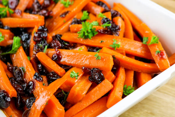 Glazed Carrots Honey and vinegar glazed carrots with parsley and cranberries side dish stock pictures, royalty-free photos & images