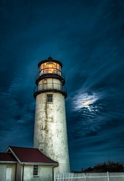 istock Historic lighthouse at twilight against dramatic sky with moonlight 837677808