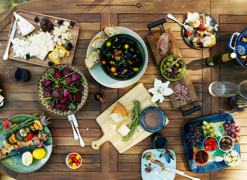 Overhead view of outdoor dining table with selection of prepared dishes