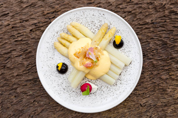 White Asparagus Mousseline Sauce Steamed white asparagus with mousseline sauce. hollandaise sauce stock pictures, royalty-free photos & images