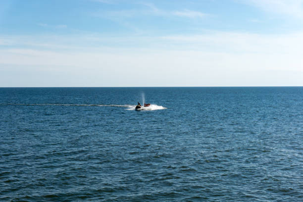 istock Man riding a water scooter at sea 837725042