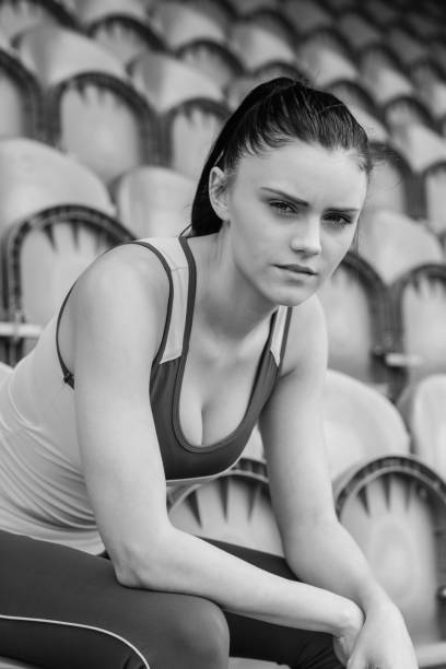 istock Serious toned woman sitting on chair in the stadium 837726500