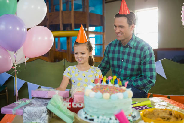 istock Father and daughter looking at gifts on table 837741596