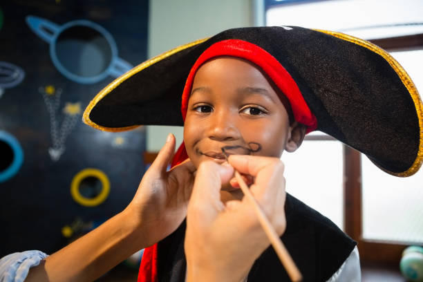 istock Hand of woman drawing mustache on boy face 837780366