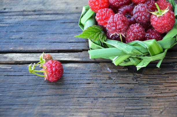 istock fresh raspberry in a basket of leaves on wooden background 837780496