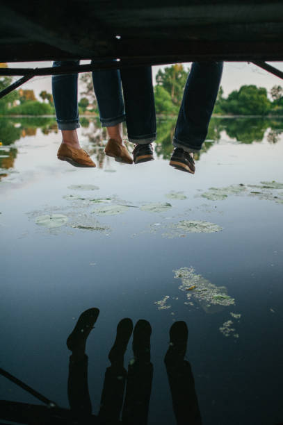 istock Cute young and happy couple on river background 837780634
