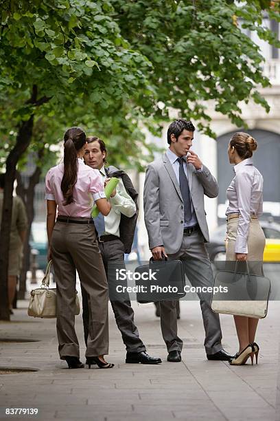 Business Team Talking On Street Stock Photo - Download Image Now - Outdoors, Businessman, Briefcase