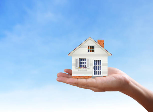 istock Mortgage concept by house from  hand 837848786