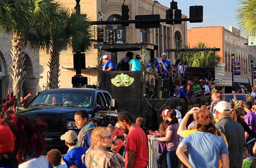 Baton Rouge, Louisiana - February 26, 2017: Crowds enjoy a festive atmosphere during Mardis Gras celebrations in downtown Lake Charles, Louisiana.