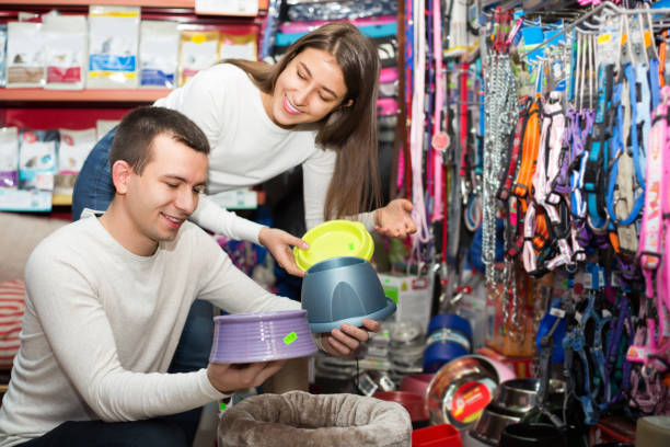 Couple choosing bowl in pet store