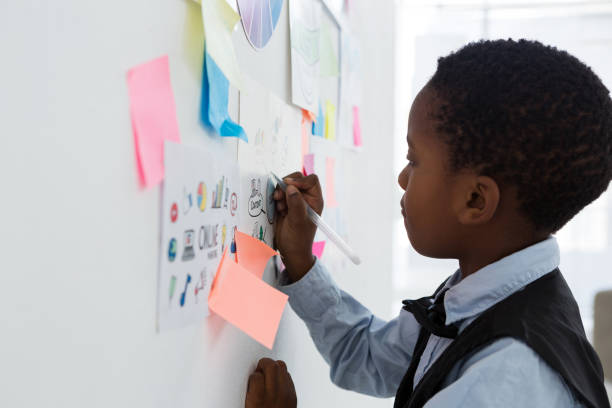 istock Businessman writing on paper at whiteboard in creative office 837860612