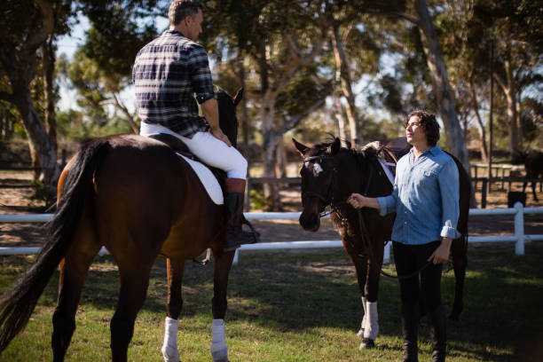 istock Two male friends interacting with each other in the ranch 837867300