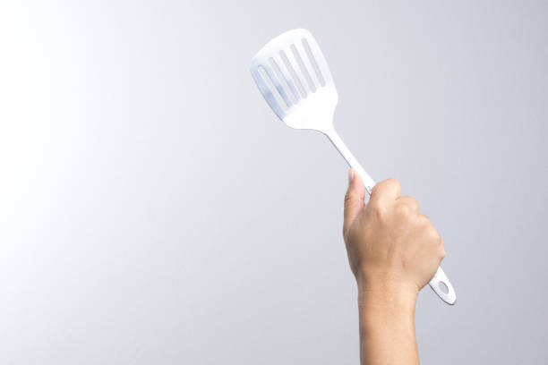 istock Hand holding stainless spade of frying pan 837912436