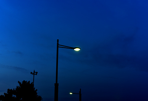 2 street lamps just after the sunset.