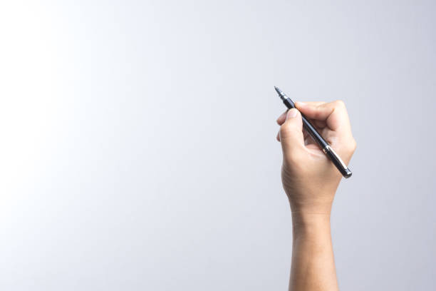istock Hand holding a pen for signing or writing 837920848
