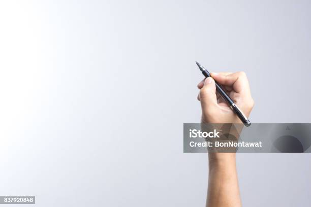 Hand Holding A Pen For Signing Or Writing Stock Photo - Download Image Now - Hand, Pen, Signing