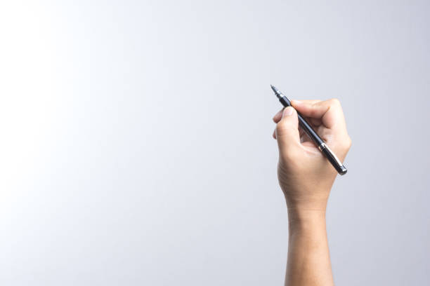 hand holding a pen for signing or writing - caneta esferográfica imagens e fotografias de stock