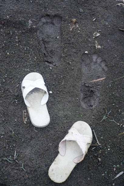istock sandal and footprint on ground. 837926754