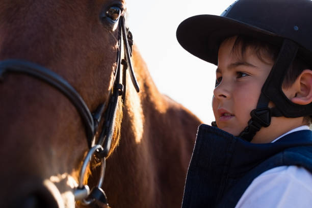 istock Rider boy caressing a horse in the ranch 837938916
