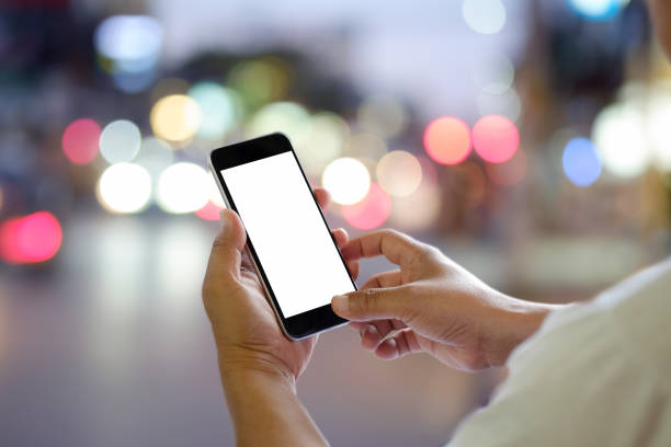istock Man using smartphone in city night. Blankscreen for graphics display montage. 837941750
