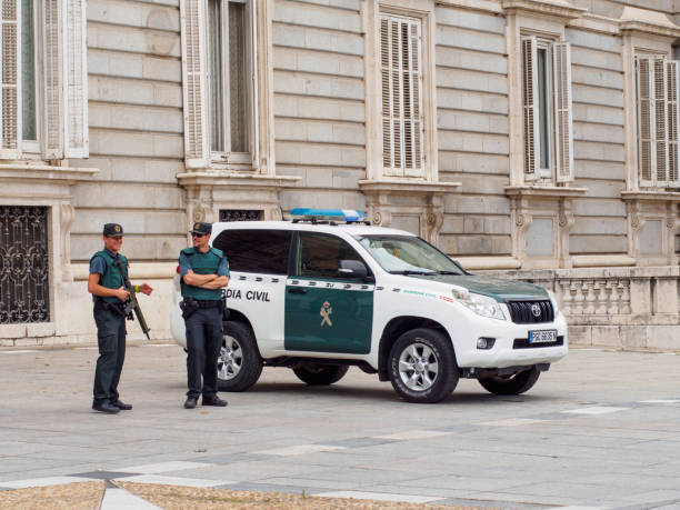 Smiling civil guardsmen on duty at Royal Palace of Madrid, Spain. stock photo