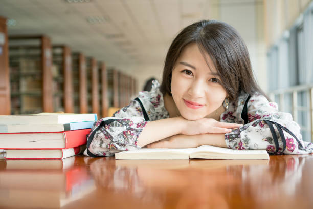 istock asian girl in library 837950280