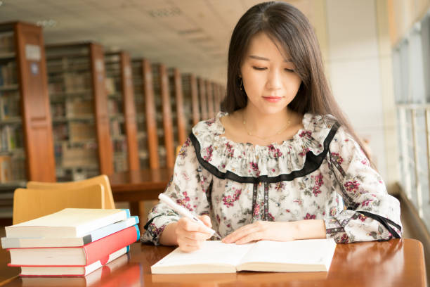 istock asian girl in library 837956452
