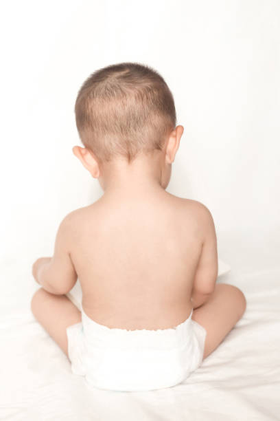 istock Baby sitting with diaper 837957532