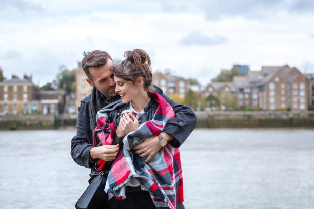 istock Romantic couple embracing against river thames 837962854