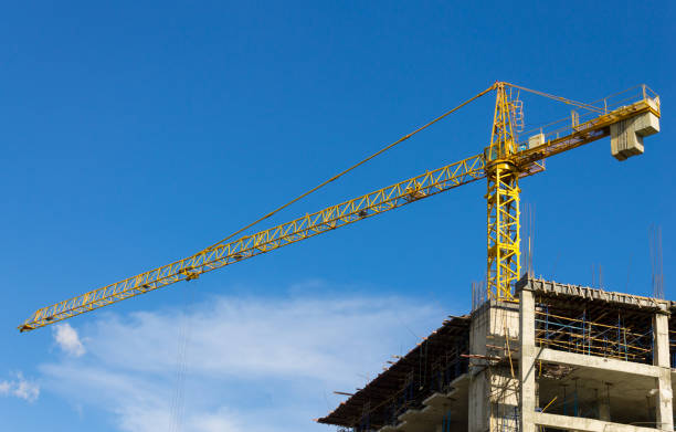 istock Tower Crane and Skyscraper on Blue Sky Background 837963198