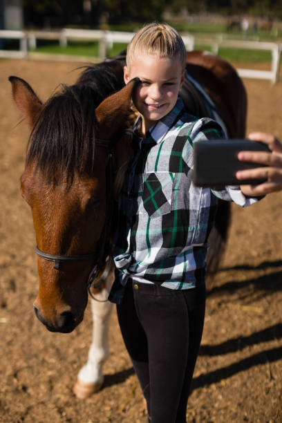 istock Girl taking a selfie with horse 837963594
