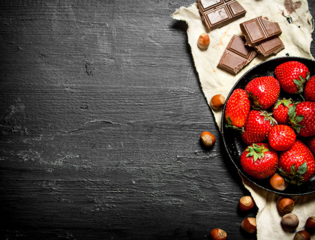 istock Strawberries with slices of chocolate and nuts. 837976468