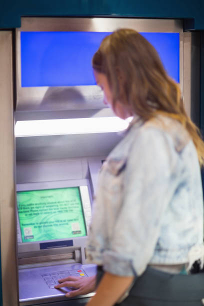 istock Student entering pin at the atm 837978566