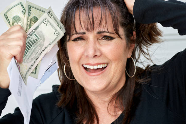 istock Middle Aged Woman panicking while Holding Bills Due and Currency 837982442
