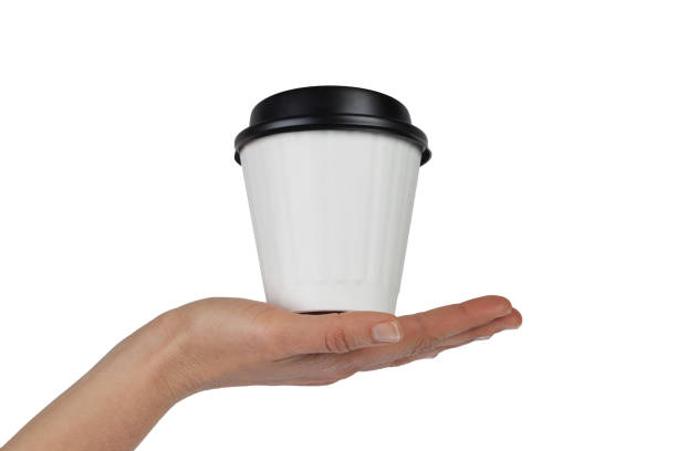istock Female hand with white disposable coffee cup in the palm isolated on white with copy space 837997346